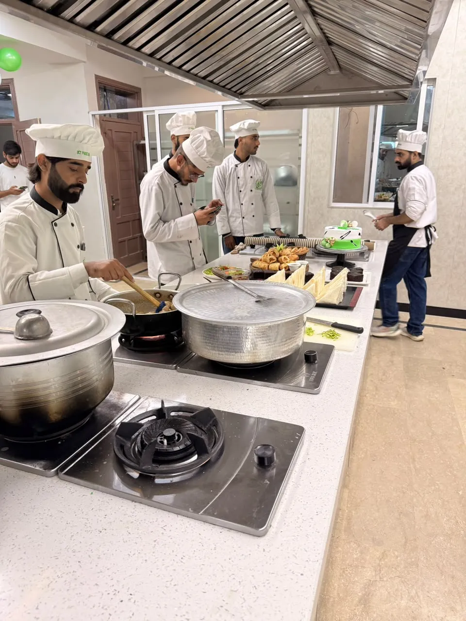 A student cooking at the stove during the Chef Day celebration